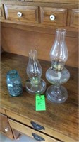 Oil lamps and ball jar full of coins