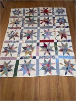 Hand stitched star quilt with feed sack backing