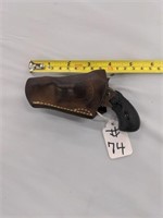 Tiny 22 revolver in leather holster, five shot