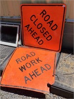 Two large hard plastic road signs