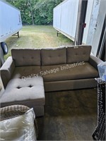 grey sofa with pull out ottoman (lobby area)