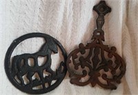 Two cast iron trivets largest one marked Wilton