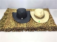 2 straw cowboy hats and leopard throw.