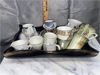 Vintage dish with demitasse cups and saucers