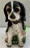 Ceramic dog statue with welcome sign