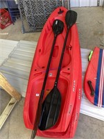Pair of kayaks with paddles. Wake board