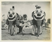 8x10 Elephants dressed as clowns holding woman