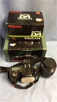 Pentax digital SLR camera with 18-55mm lens, both