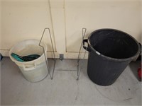 Garden hoses, trash cans, and trash bag holder