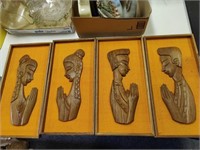 Wall plaques with wood carvings.