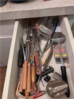 Contents of drawer mainly utensils