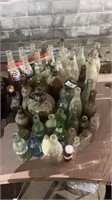 Lot of assorted glass bottles, jugs, flasks, and