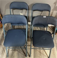 Four padded folding chairs.