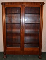 Mahogany two door bookcase with columns and carvet