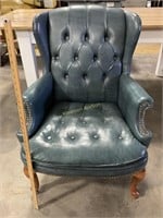 Blue leather looking wing back tufted chair. Has