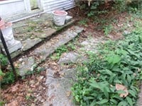 Entrance to home is uneven & overgrown