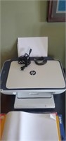 HP desk jet with power cord and printer paper