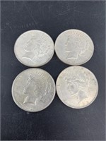 Four 1922 silver Peace dollars