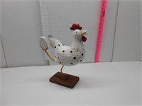 Rooster with Egg in Foot
