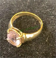 Marked 14 K gold tone ring with a large pink