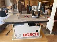 Bosch router table with router and plunger.