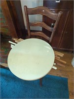 Two round press board end tables and a chair