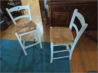 Two white wooden bar stools