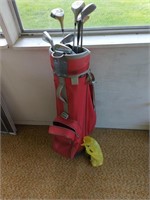 Golf bag with clubs, tees, and balls