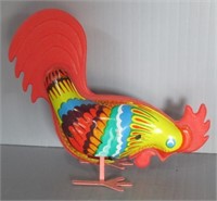 Vintage tin and plastic windup rooster toy.