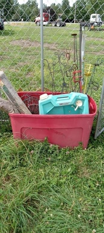 Red tote of garden art and gardening supplies