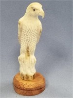 Beautiful antler carving of a parrot on a hardwood