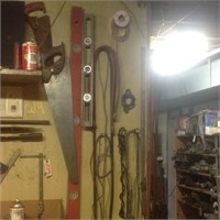 tools on wall - saws, levels, hoses, etc.