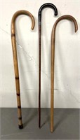 Three wooden canes 2 w/ signage