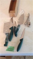 Green handled knives and measuring spoons