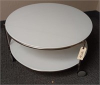 Round glass coffee table on wheels