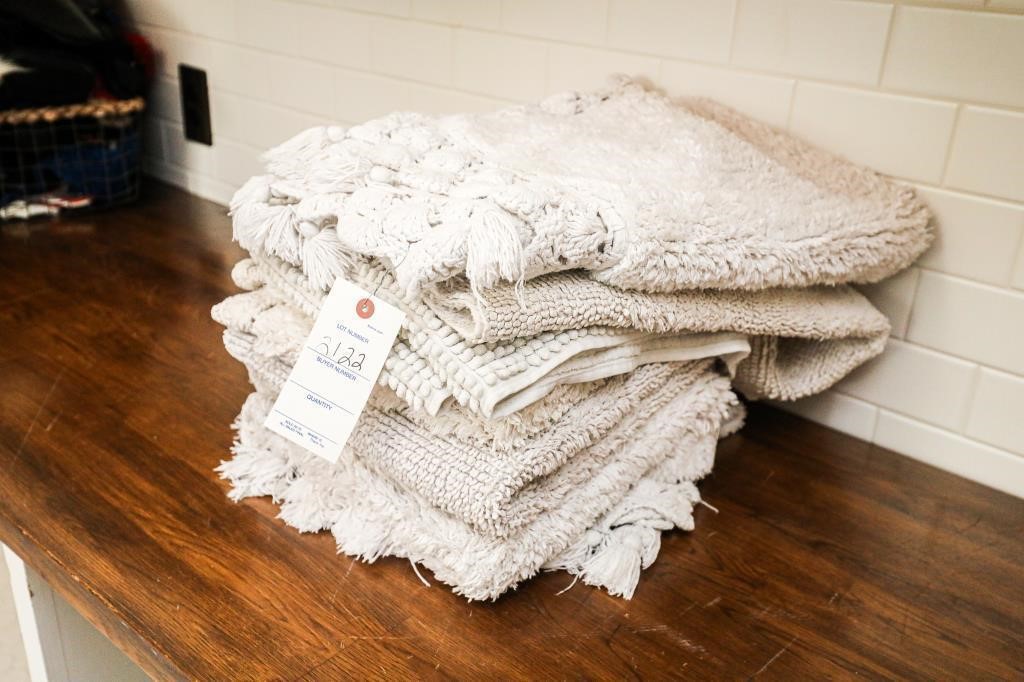 Stack of White Cotton Throw Rugs