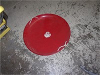 Old red metal round sled
