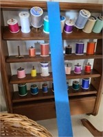 Sewing items Thread on shelf, basket, scale,
