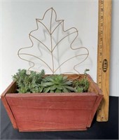 Succulents in wood pot with leaf wire decor