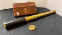 Brass periscope with lens cap and storage box.