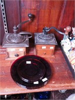 Two vintage coffee grinders and seven red glass
