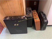 Group of four briefcases and sample cases