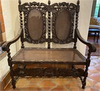 Antique heavily carved two-seat bench