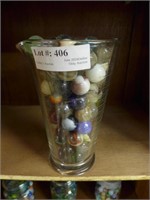 Pitcher with large assortment shooter marbles