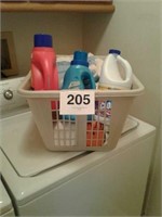 LAUNDRY BASKET FULL OF TOWELS AND LAUNDRY SOAPS