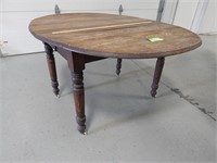 Antique drop leaf table on casters; tabletop appro