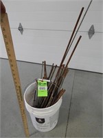 Bucket with assorted lengths of threaded rod