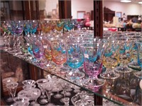 34 multi-colored pieces of glassware with clear