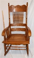 ANTIQUE OAK PRESSED BACK CANED SEAT ROCKING CHAIR