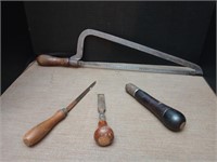 Vintage hand tools including a saw, chisel and
